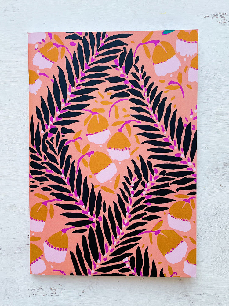 Front Cover of Peach Poetry A5 Notebook Featuring Black Leaves on Intertwining Branches with Semi-Abstract Flowers in Light Brown on a Peach Pink Background.