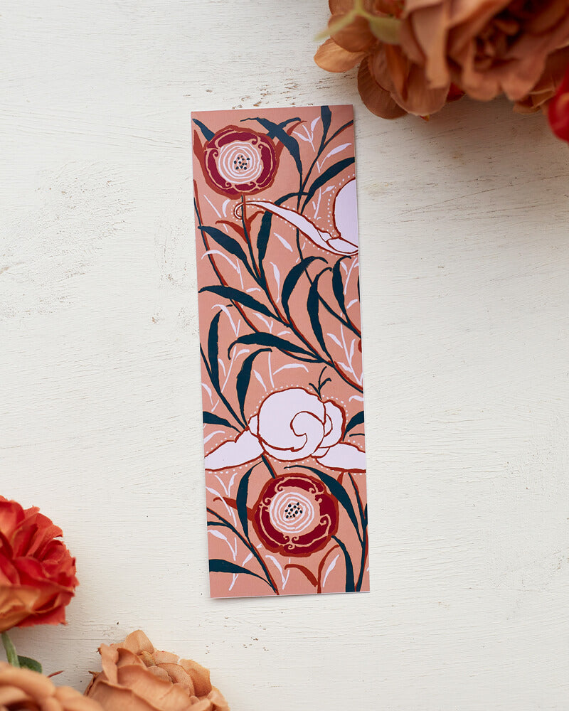 A glossy 2 x 6 inch bookmark depicting delicate branches, scrolling leaves, and semi-abstract flowers.