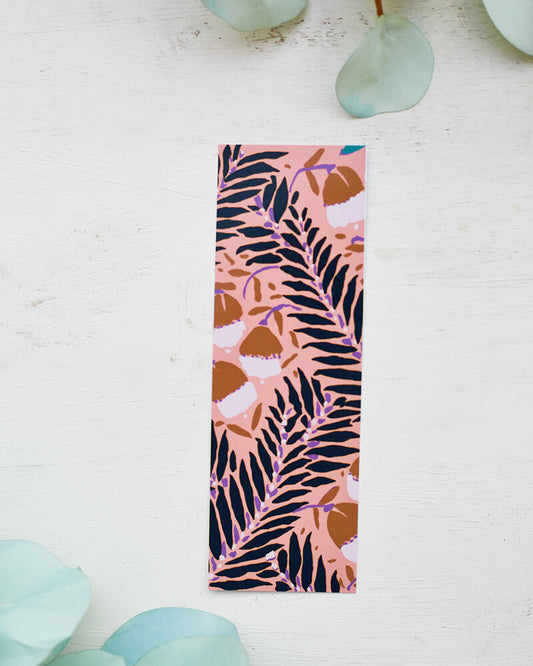 A glossy 2 x 6 bookmark depicting scrolling branches, abstract flowers, and a peachy pink background.