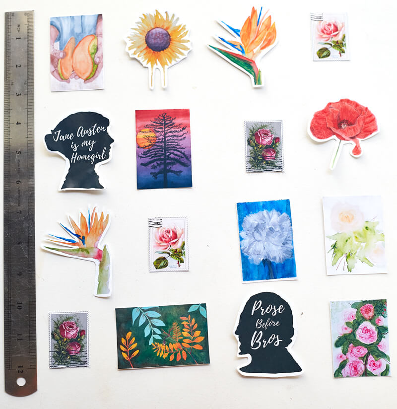 A metal ruler next to assorted stickers with botanical and floral themes, some vintage stamp themes, a silhouette of Jane Austen with the words "Jane Austen is my homegirl" and a silhouette of William Shakespeare with the words "Prose Before Bros"