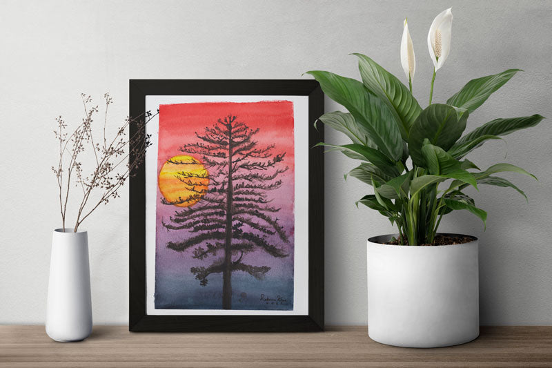 A table with two vases with plants and a framed watercolor painting of a thin black tree in front of a sunset with a red sky fading into black.