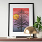A shelf with a small lamp, a small plant and a watercolor painting of a thin black tree in front of a sunset with a red sky fading into black.