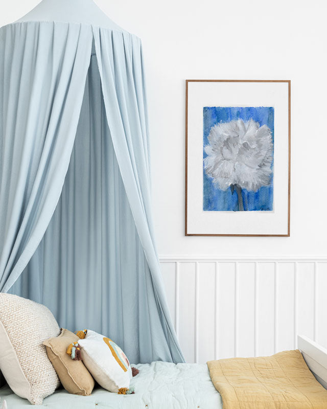 Art print of a mix media abstract floral painting of a white carnation on a blue background in a kids bedroom or nursery.